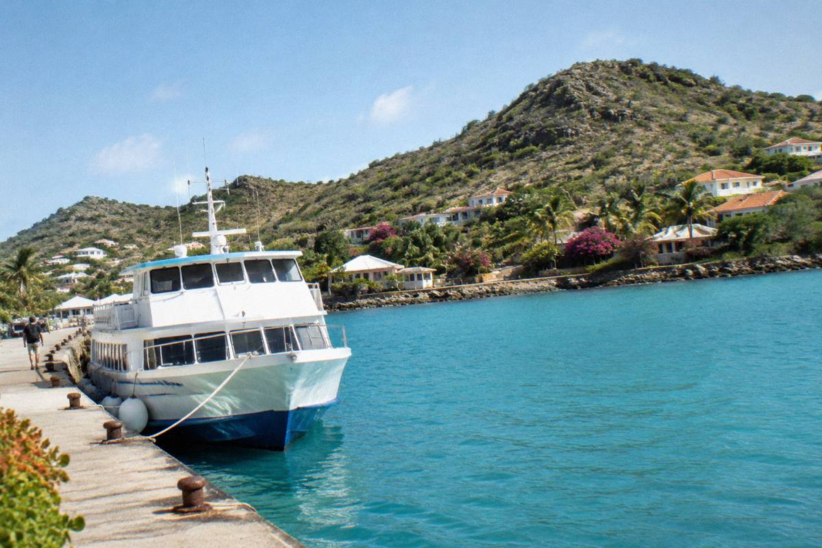A passenger ferry moored at a Caribbean waterfront dock in morning light