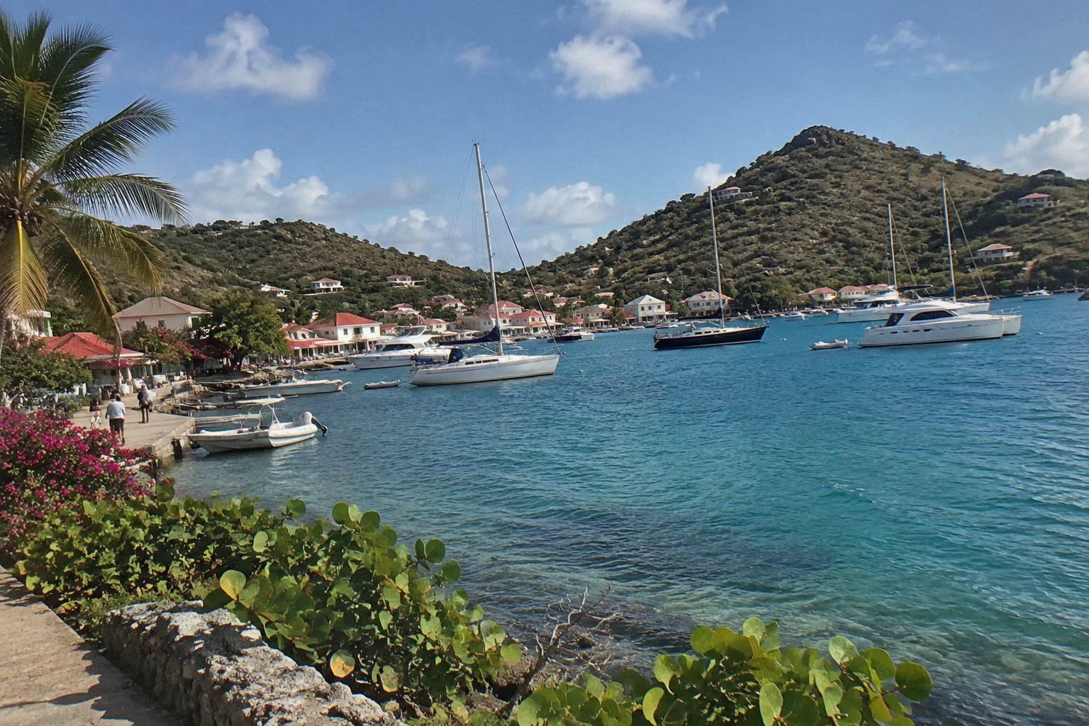 Harbour front of Gustavia with boats moored in the bay at late afternoon