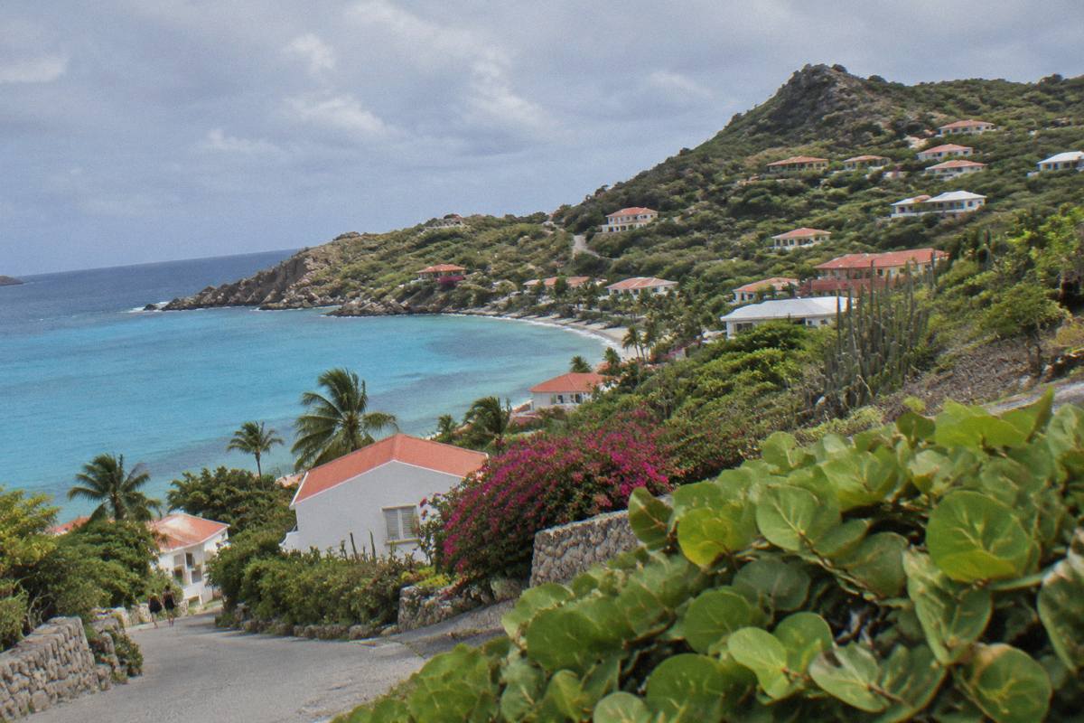 Historic stone buildings with white facades along a quiet street in Gustavia