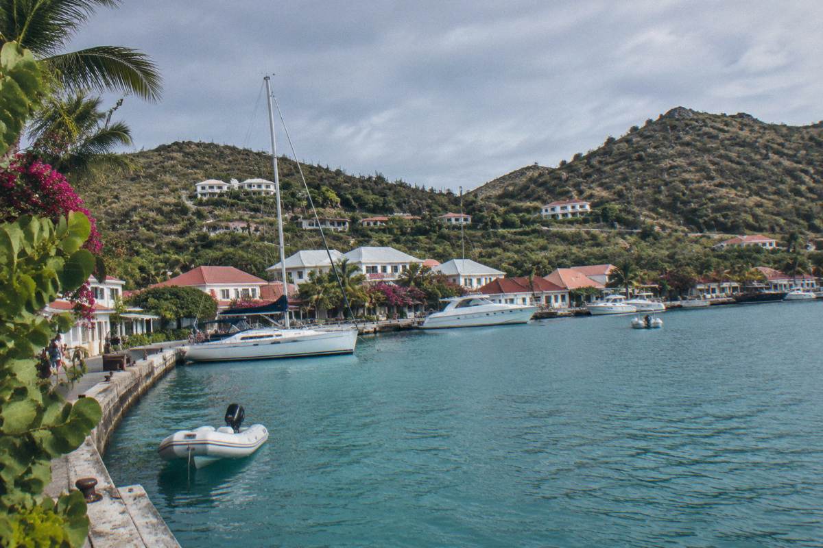 Harbour town waterfront with boats moored beside low buildings on Saint Barthelemy