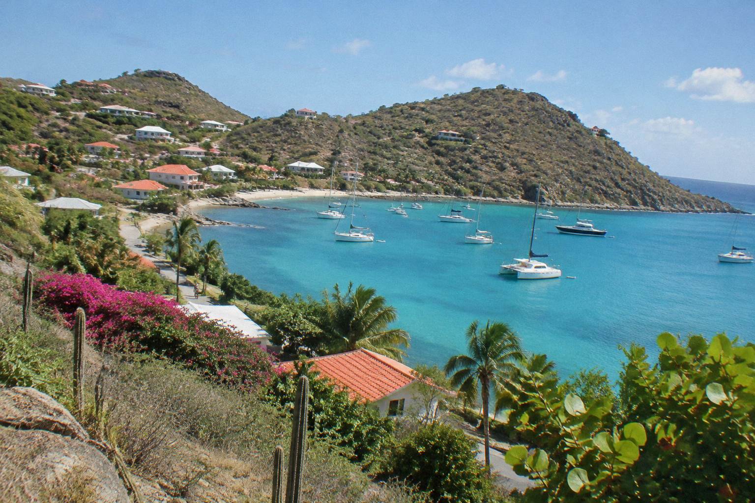 Turquoise bay on Saint Barthelemy with hillsides and anchored boats