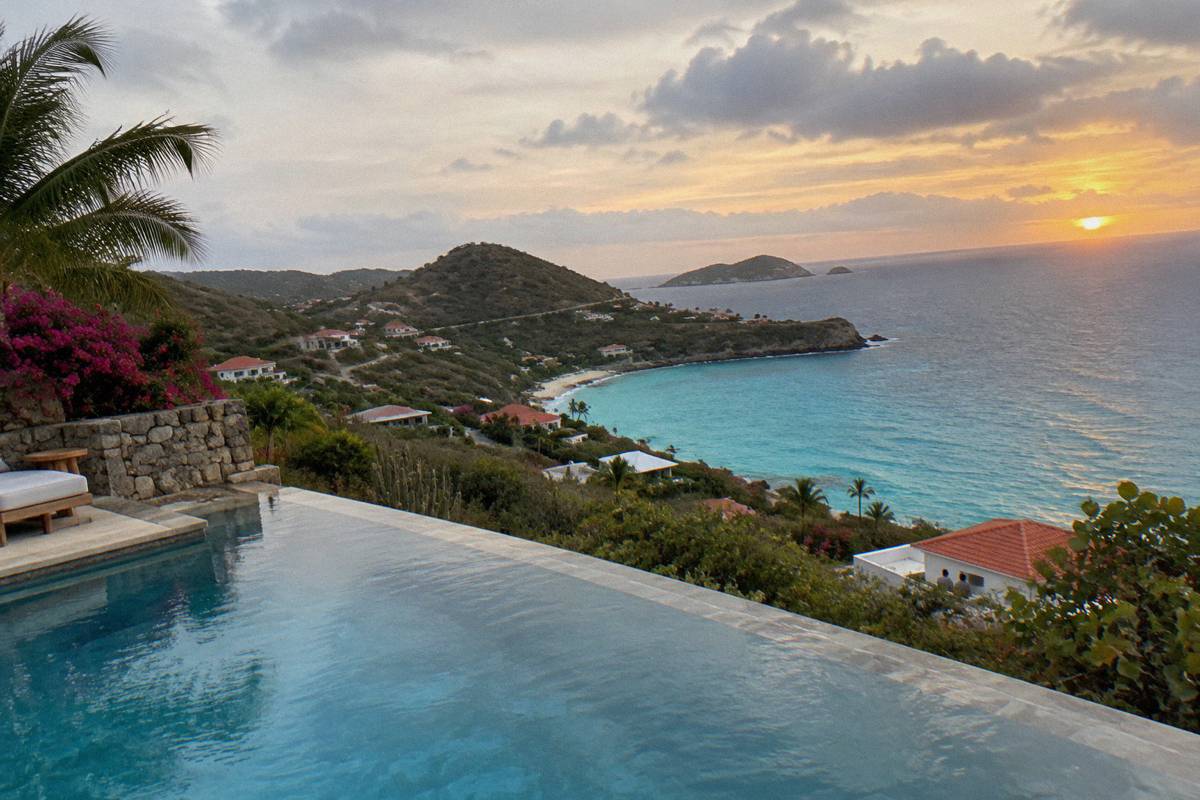 Infinity pool on a cliff terrace overlooking the open sea at sunset