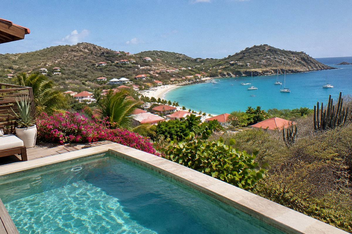 Private terrace with a plunge pool overlooking a bay and village rooftops