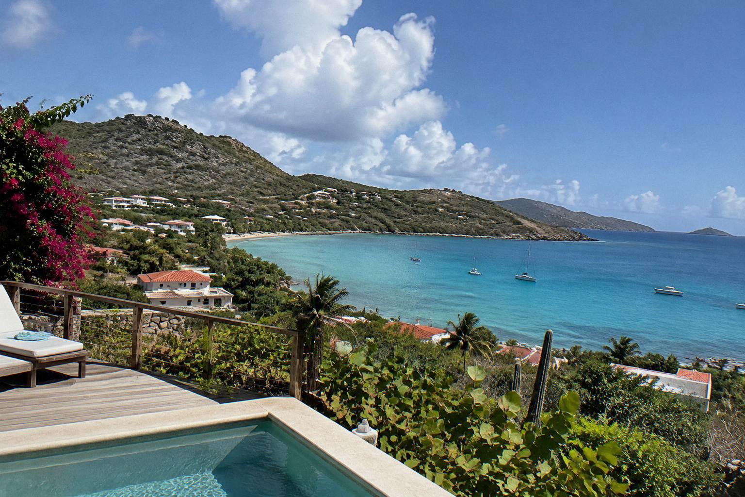 Resort terrace overlooking a calm turquoise bay in Saint Barthelemy at midday